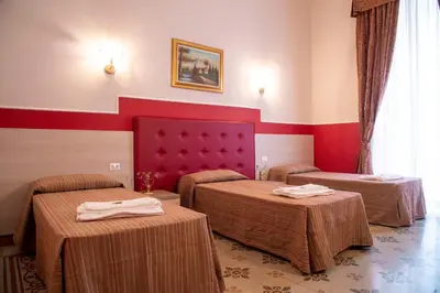 a hotel room with two beds in a room at Domus Napoleone in Rome