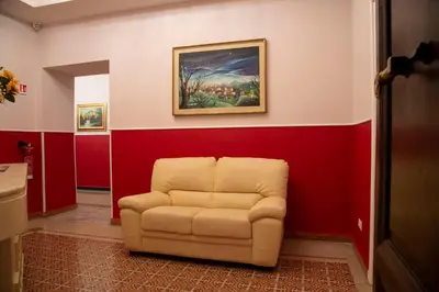 a chair in a room with a painting on the wall at Domus Napoleone in Rome
