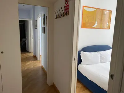 a bedroom with a bed with a blue head board at Civico43 in Rome