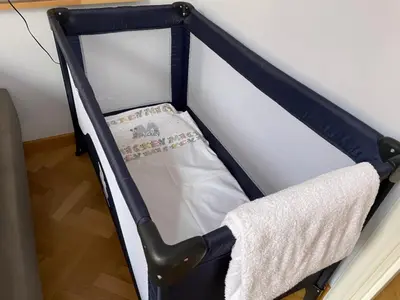 a baby crib with a blanket in a room at Civico43 in Rome