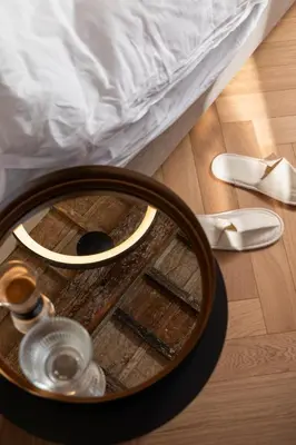 a mirror sitting on the floor next to a bed at Efes Hôtellerie in Rome