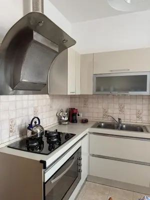 a kitchen with a stove top oven next to a sink at DolceCasa - Re di Roma Apartment in Rome