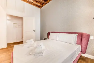 a bedroom with a large bed with a red frame at APT ROME Fratte di Trastevere in Rome