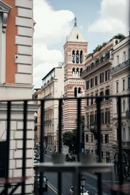 a tall building with a clock tower in a city at Casa Mia Nazionale in Rome