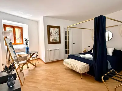 a bedroom with a bed and a table in a room at Casa JULIA in Rome