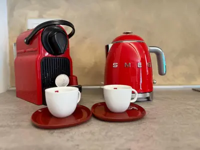 two cups on plates next to a tea kettle at Casa JULIA in Rome
