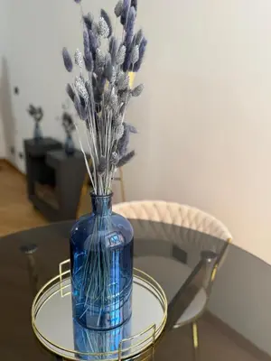 a blue vase with flowers sitting on a table at Casa JULIA in Rome