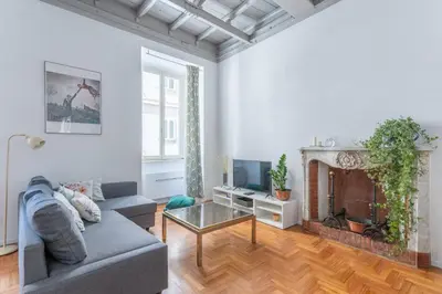a living room with a couch and a fireplace at Elegance near Navona-for 5 guests in Rome