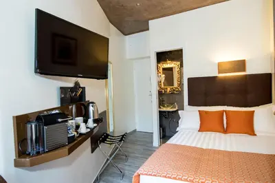 a hotel room with a bed and a flat screen tv at Vaticano Julia Guest House in Rome