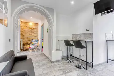 a living room with a couch and two stools at ARDECORE VIA VIGEVANO Guest House o Affittacamere in Rome