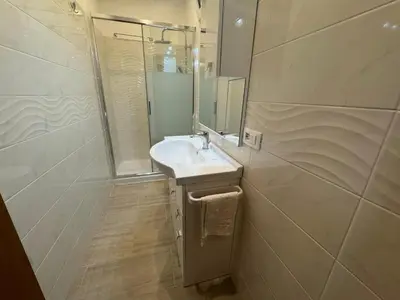 a white bathroom with a sink and a mirror at B&B Kevin's Home in Rome