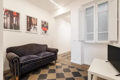 a living room with a couch and a tv at Top Location - walk to Navona Pantheon and Vatican in Rome