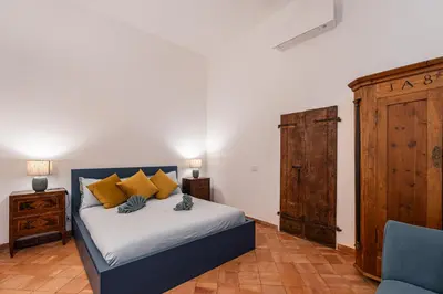 a bedroom with a bed with yellow pillows at Apartment AppiaAntica in Rome