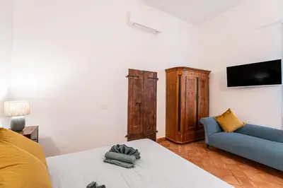 a living room with a couch and a tv at Apartment AppiaAntica in Rome