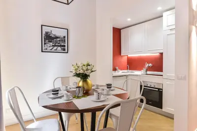 a kitchen and dining room with a table and chairs at EVE Luxury Apartments Pantheon in Rome