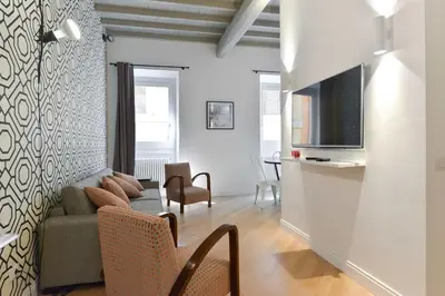 a living room with a couch and a tv at EVE Luxury Apartments Pantheon in Rome