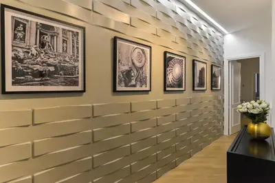 a wall of framed pictures in a hallway at EVE Luxury Apartments Pantheon in Rome