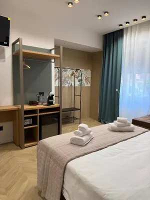 a bedroom with a bed with towels on it at Ulivo Guest House Roma in Rome