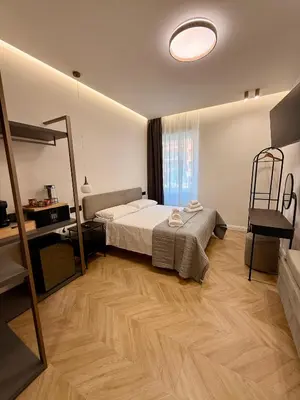 a bedroom with a bed and a mirror in it at Ulivo Guest House Roma in Rome