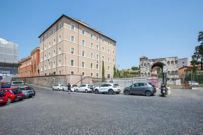 a parking lot with cars parked in front of a building at TreasureRome Forum Terrace in Rome