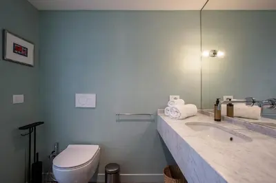 a bathroom with a toilet and a sink and a mirror at TreasureRome Forum Terrace in Rome
