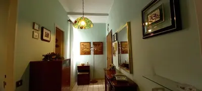 a hallway with a room with a chandelier at casawally MetroB Marconi SanPaoloBasilica Colosseo in Rome