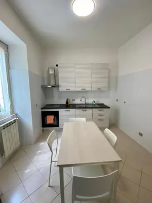 a kitchen with a table and chairs in a room at Coral Apartment in Rome