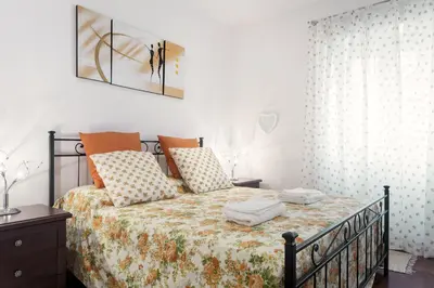 a bedroom with a bed with a comforter and pillows at Le Scalette Al Vaticano B&B in Rome