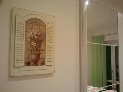 a picture of a vase of flowers on a wall at Le Scalette Al Vaticano B&B in Rome