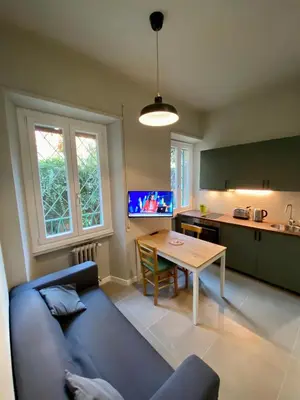 a living room with a blue couch and a table at Balduina Boutique Apartment in Rome