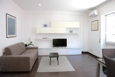a living room with a couch and a tv at Nice flat near Trastevere Station in Rome