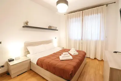 a bedroom with a bed with two towels on it at Free Parking Chic Home - Balcony, AC, Wi-Fi in Rome