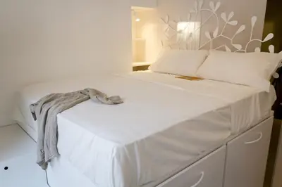 a bedroom with a white bed with a blanket on it at La Casa Di Iulia in Rome