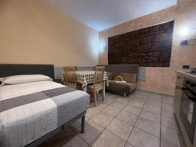 a bedroom with a bed and a table and chairs at Family Apartment for five persons in Rome