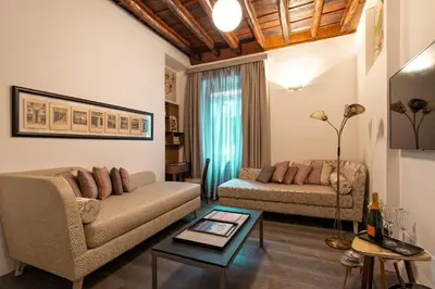 a living room with a couch and a table at Maison Evelina in Rome