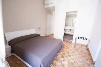 a small bedroom with a bed and a bathroom at Vantaggio Apartment in Rome