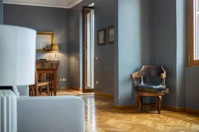 a living room with a chair and a table at Santonofrio SKY Terrace Penthouse in Rome