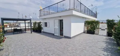 a balcony of a white building with a bench on it at Nox Romana Apartment - Polyclinic Gemelli - Penthouse with Large Panoramic View Terrace in Rome