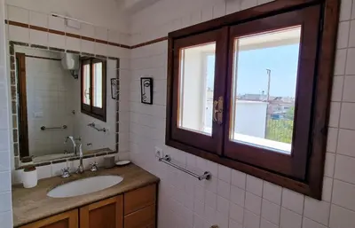 a bathroom with a sink and a mirror and a window at Nox Romana Apartment - Polyclinic Gemelli - Penthouse with Large Panoramic View Terrace in Rome