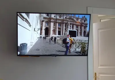 a flat screen tv hanging on a wall at SR Guesthouse in Rome