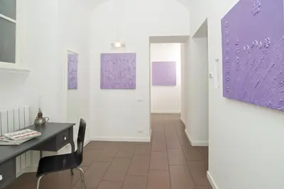 a room with a desk and paintings on the wall at Germanico Maxi in Rome
