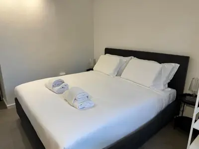 a large white bed with two towels on it at Rome design and fitness stay - Pantheon and Trevi in Rome