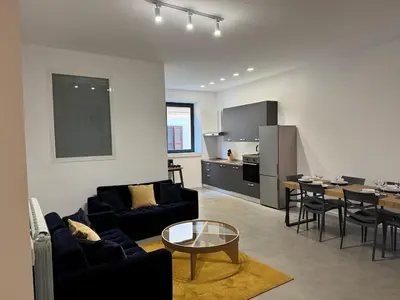 a living room with couches and a table and a kitchen at Rome design and fitness stay - Pantheon and Trevi in Rome