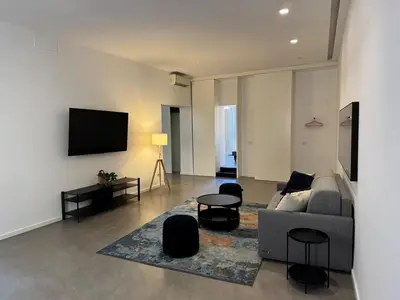a living room with a couch and a flat screen tv at Rome design and fitness stay - Pantheon and Trevi in Rome