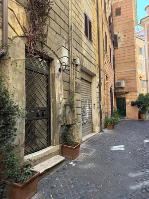 an empty street with a building and some plants at Rome design and fitness stay - Pantheon and Trevi in Rome