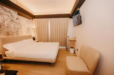 a bedroom with a bed and a chair at Guest House Praesidium in Rome