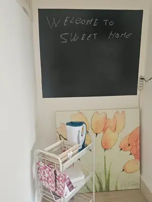 a blackboard on the wall above a shelf in a room at SWEET HOME Porta Maggiore in Rome