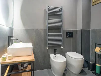 a bathroom with a white toilet and a sink at Relax e Style, Kairos, the house of quality time in Rome