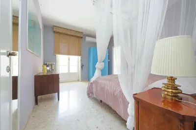 a bedroom with a bed with a white canopy at Pascarella - Trastevere in Rome