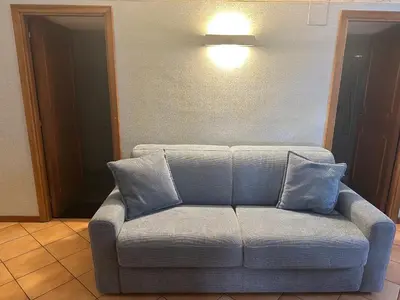 a couch with blue pillows in a living room at Apt Aurea Domus al Pantheon in Rome
